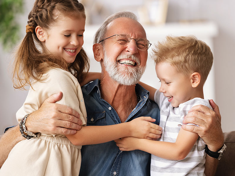 grandfather smiling with grandkids
